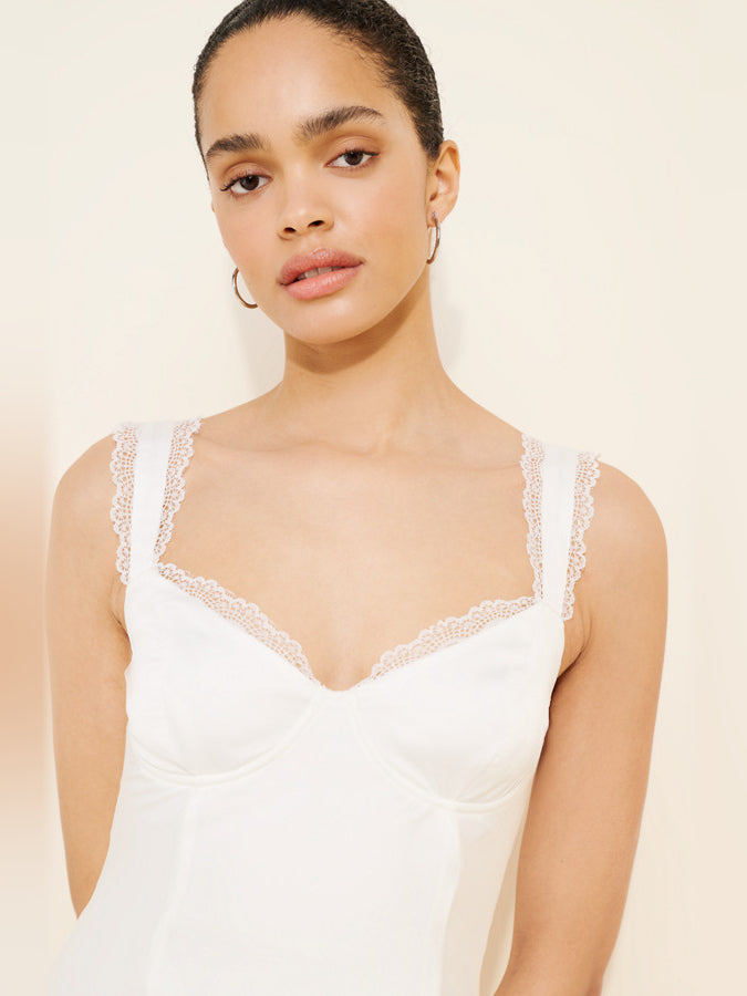 White lace-trim mini dress close-up: square neckline, thin straps, fitted bodice