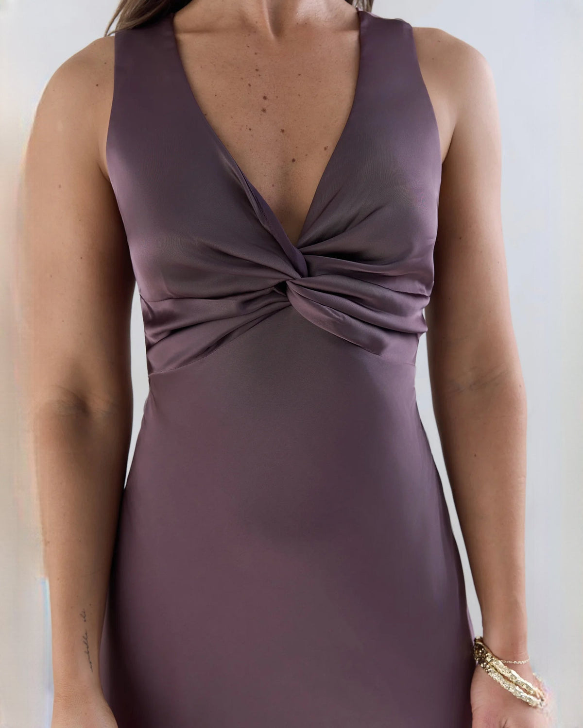 Purple satin sleeveless maxi dress bodice with twisted knot detail.