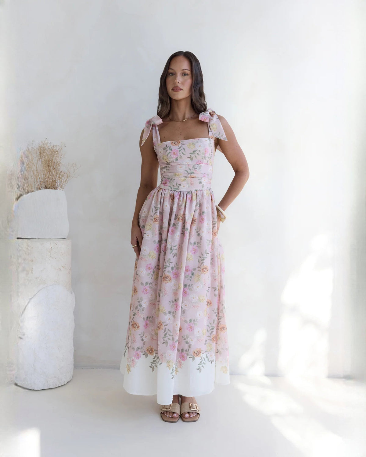 Pink floral sleeveless satin A-line maxi dress with square neckline and bow detail