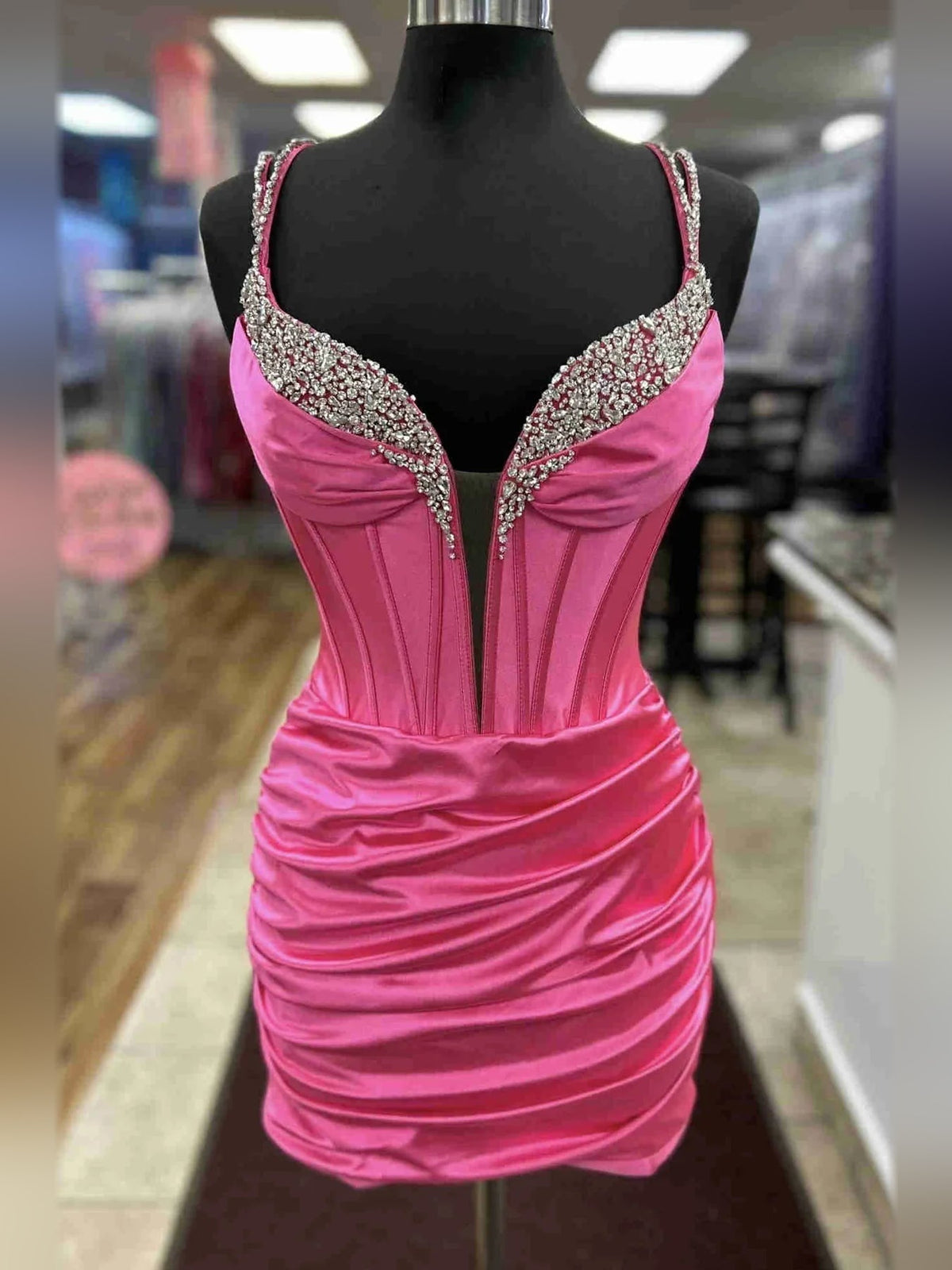 Hot pink satin corset mini dress with ruched bodice, sweetheart neckline and jeweled trim