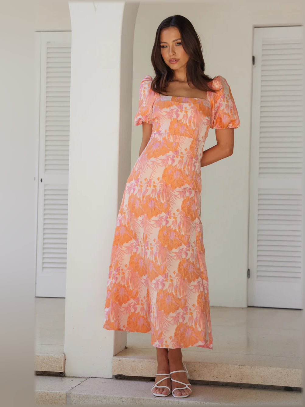 Coral-pink midi formal dress with abstract floral print, square neck, puff sleeves, front view