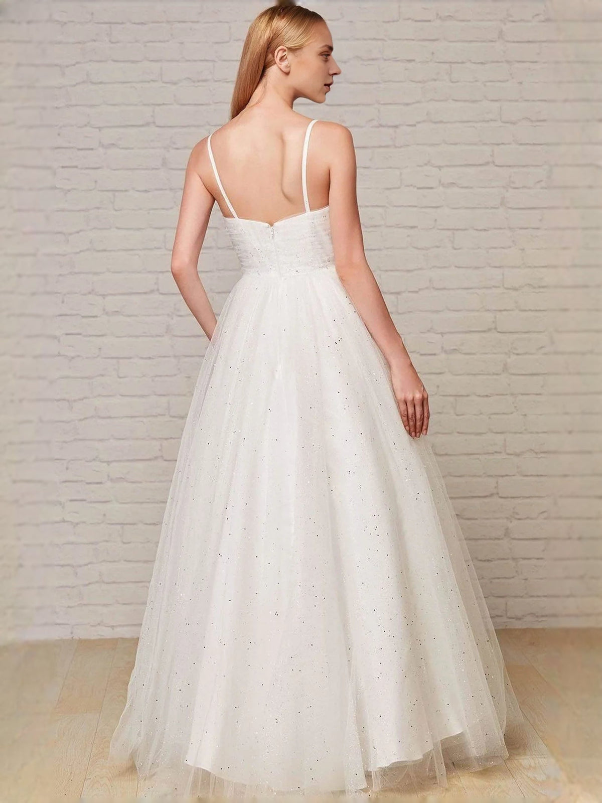 White glitter prom dress back view with spaghetti straps and A-line tulle skirt