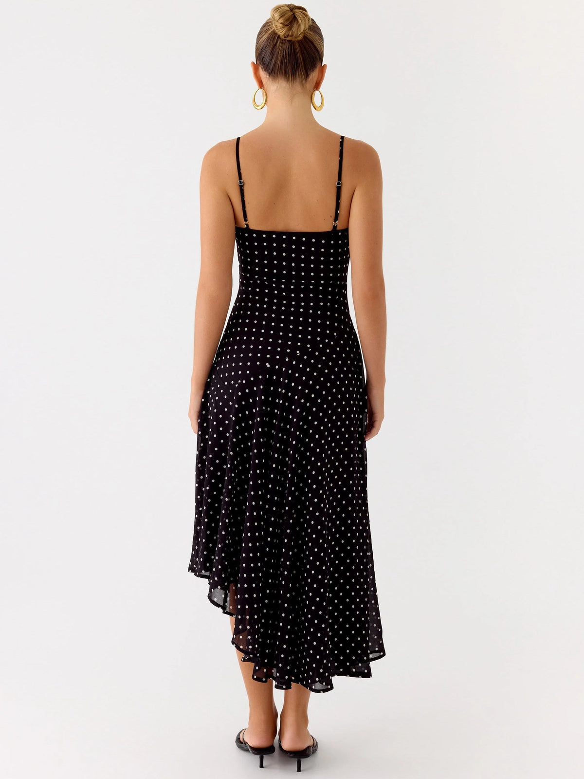 Black midi formal dress back view with thin spaghetti straps and allover dotted sparkle, asym hem