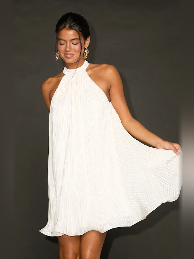 Ivory high-neck pleated mini dress with flowy skirt; halter neckline detail