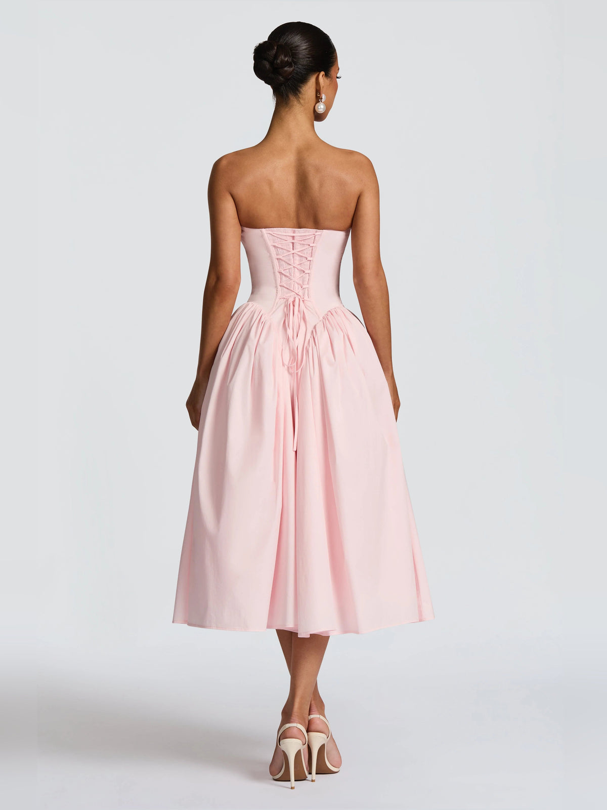 Blush strapless midi formal dress with corset back detailing and pleated skirt