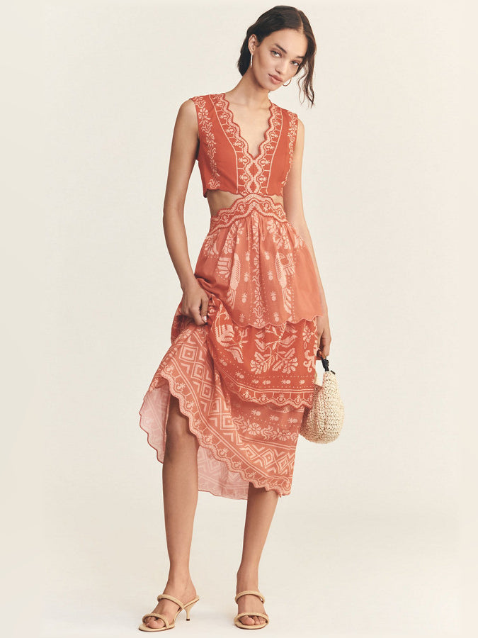 Orange eyelet tiered ruffle midi dress with gathered waist and patterned skirt tiers