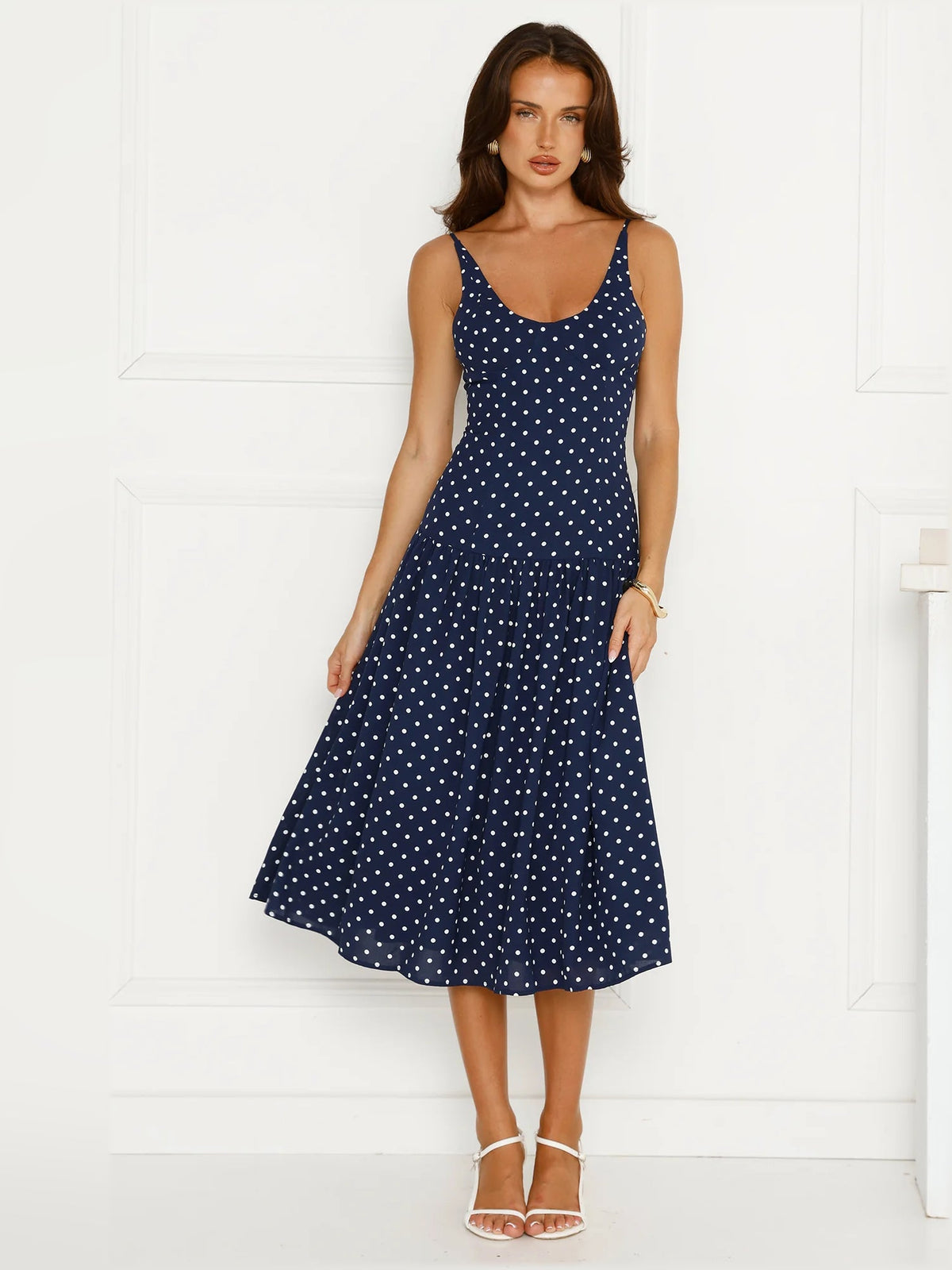 Navy polka dot midi dress with scoop neckline and flared skirt