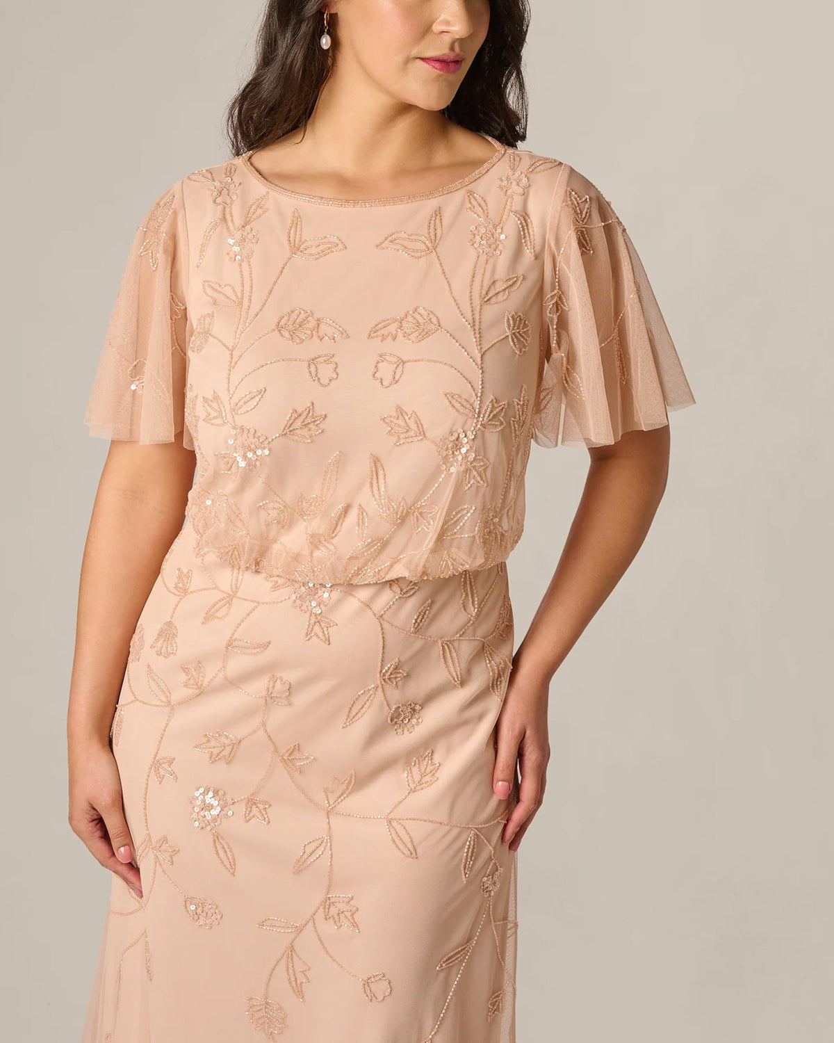 Blush pink dress top with round neckline, flutter sleeves, and floral sequin embroidery