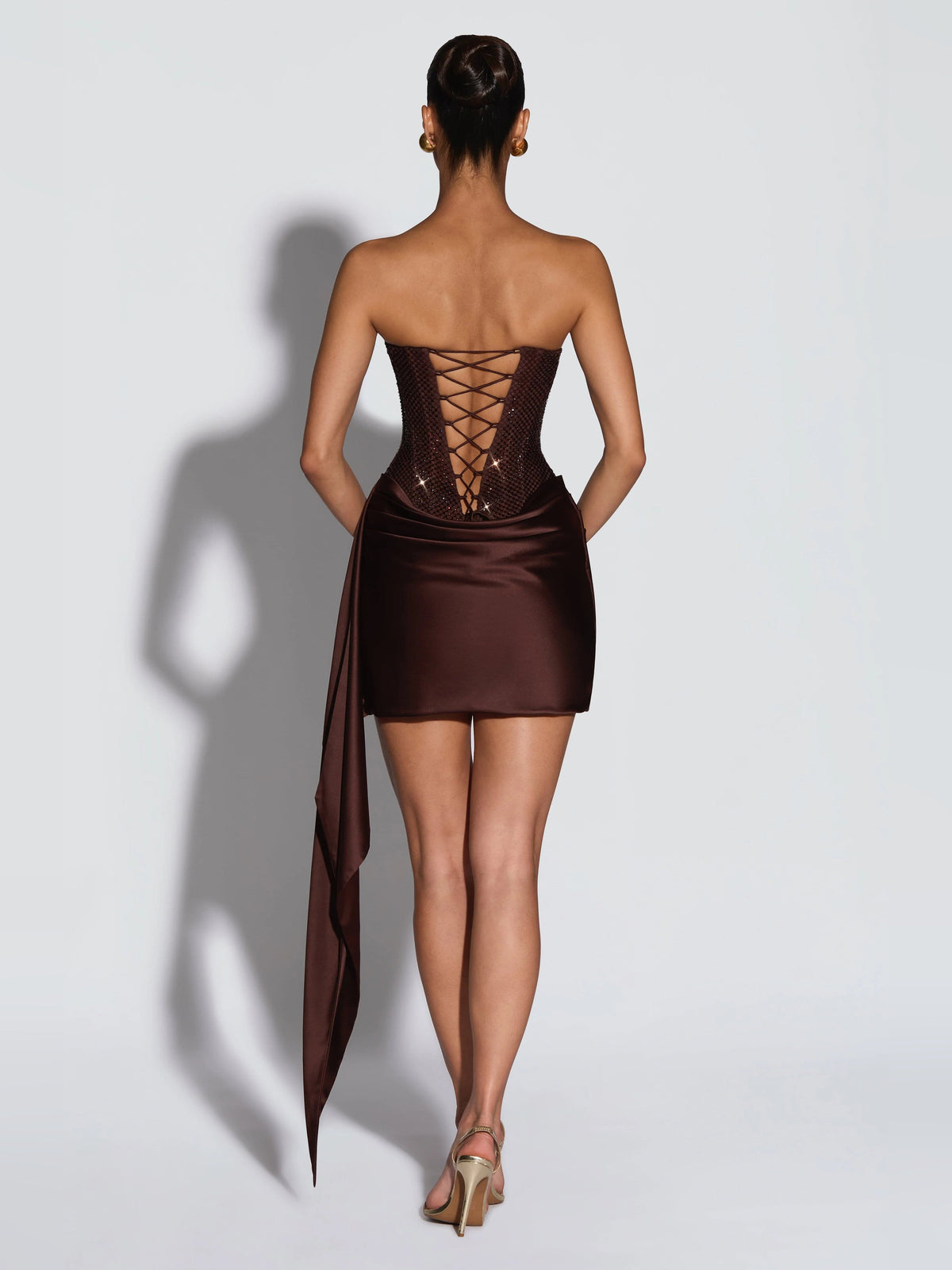 Backless brown mini dress with crisscross lacing corset and draped satin wrap