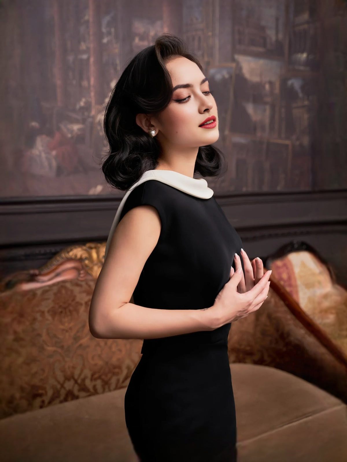 Black sleeveless mermaid maxi dress with white collar trim, side view