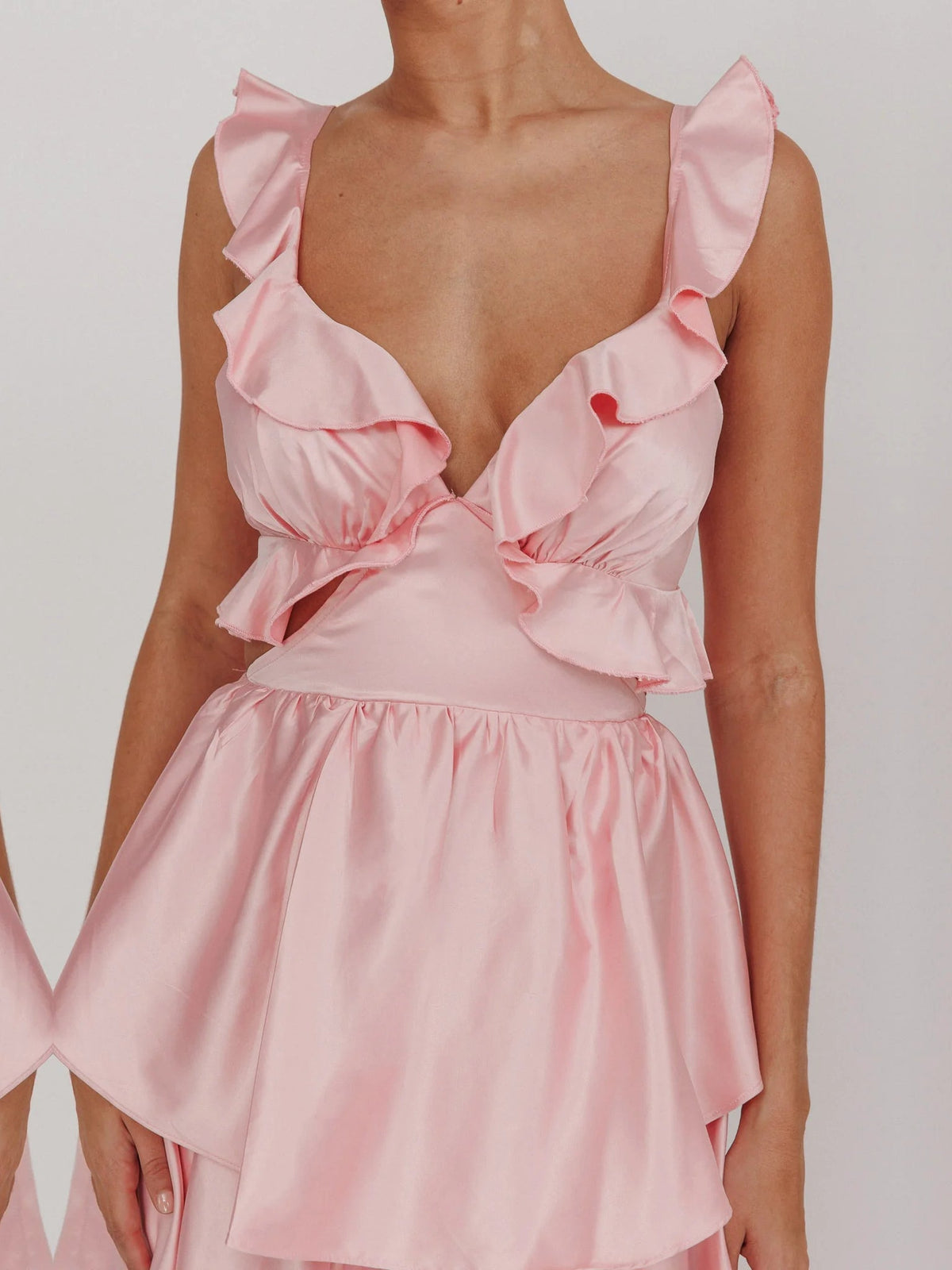 Pink V-neck tiered ruffle bodice with puffed ruffle sleeves and gathered waist