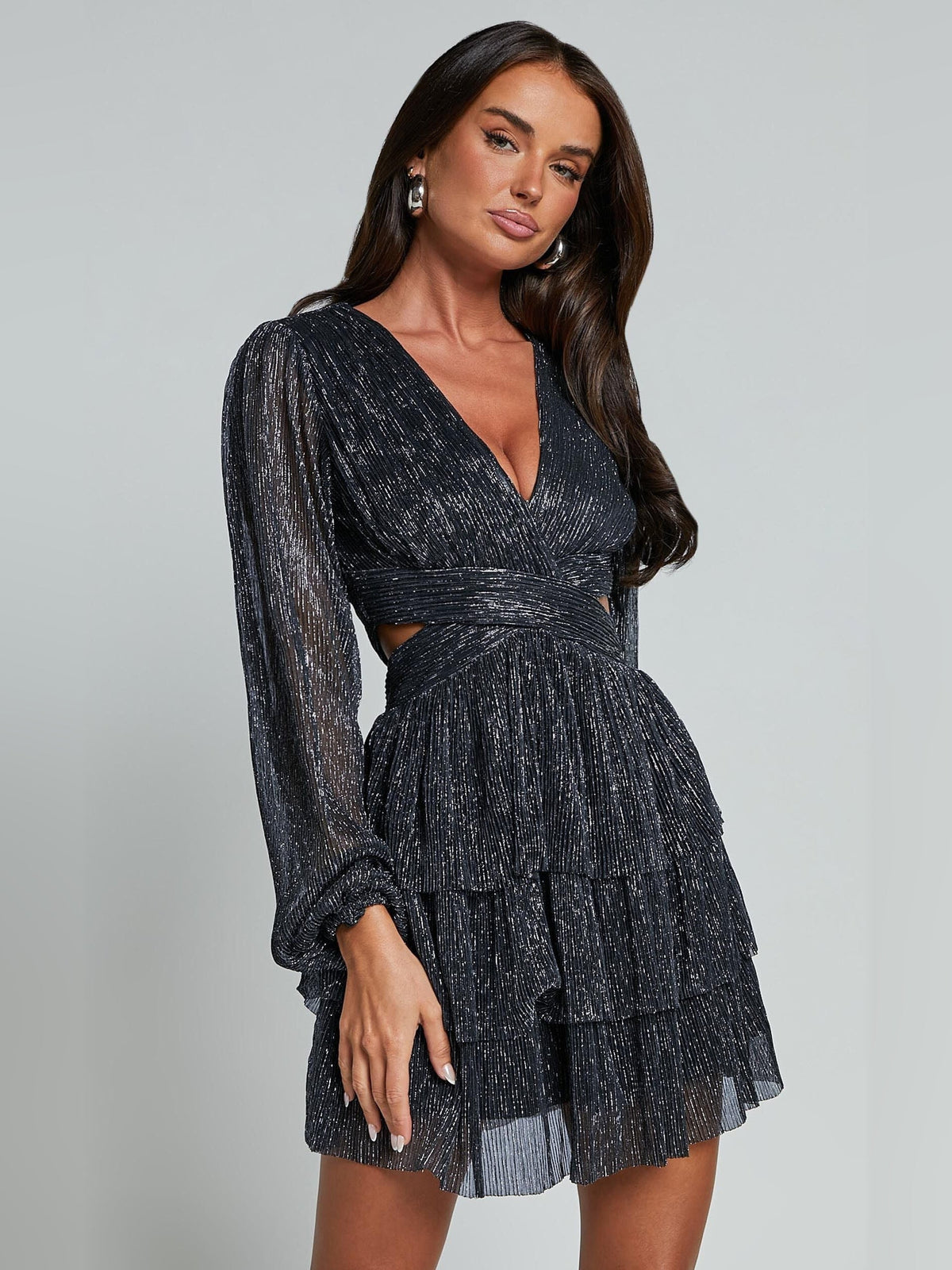 Black long-sleeve mini dress with deep V-neck and tiered pleated skirt