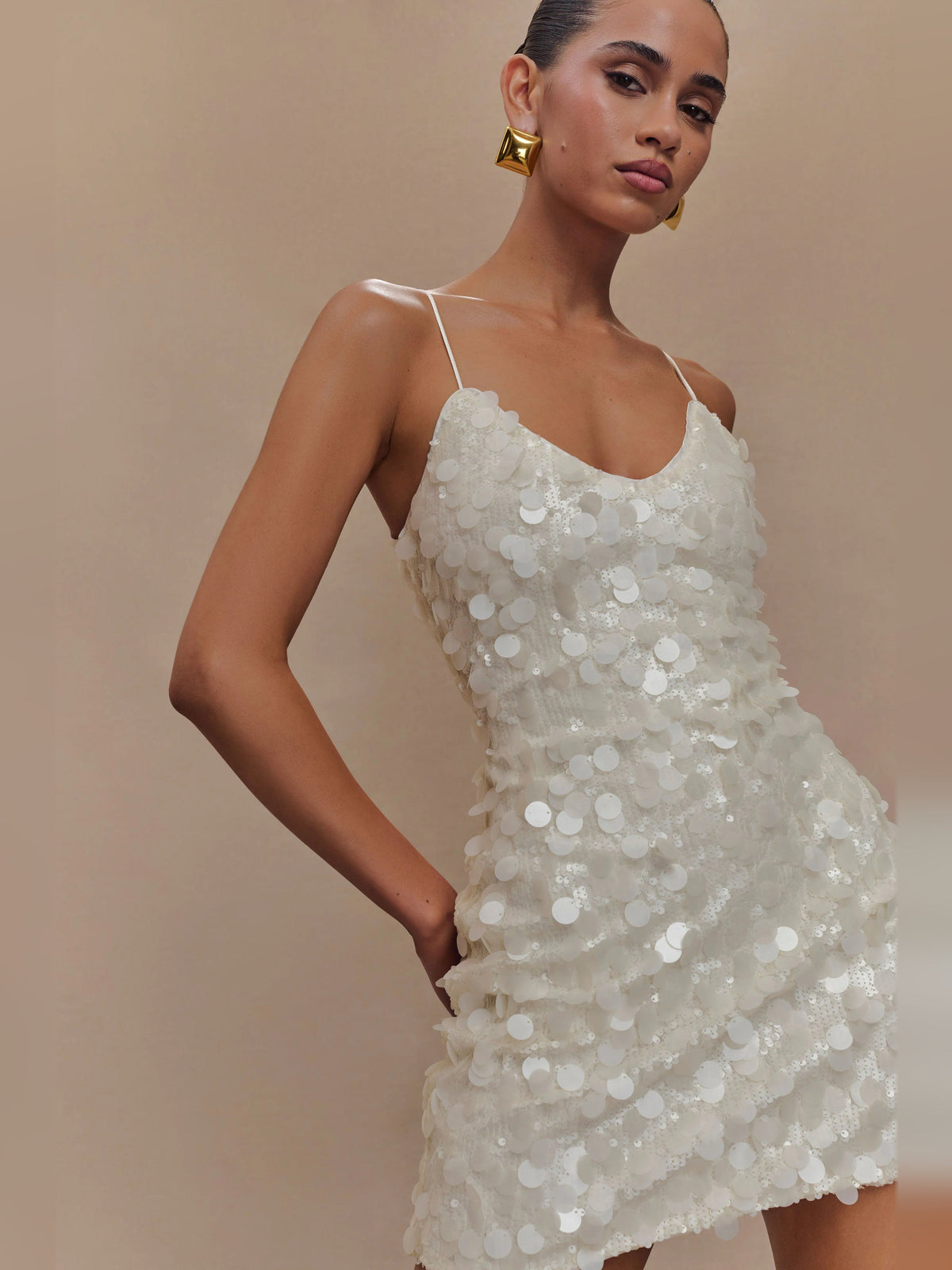 Ivory sequin mini dress with V-neckline, spaghetti straps, and layered sparkle