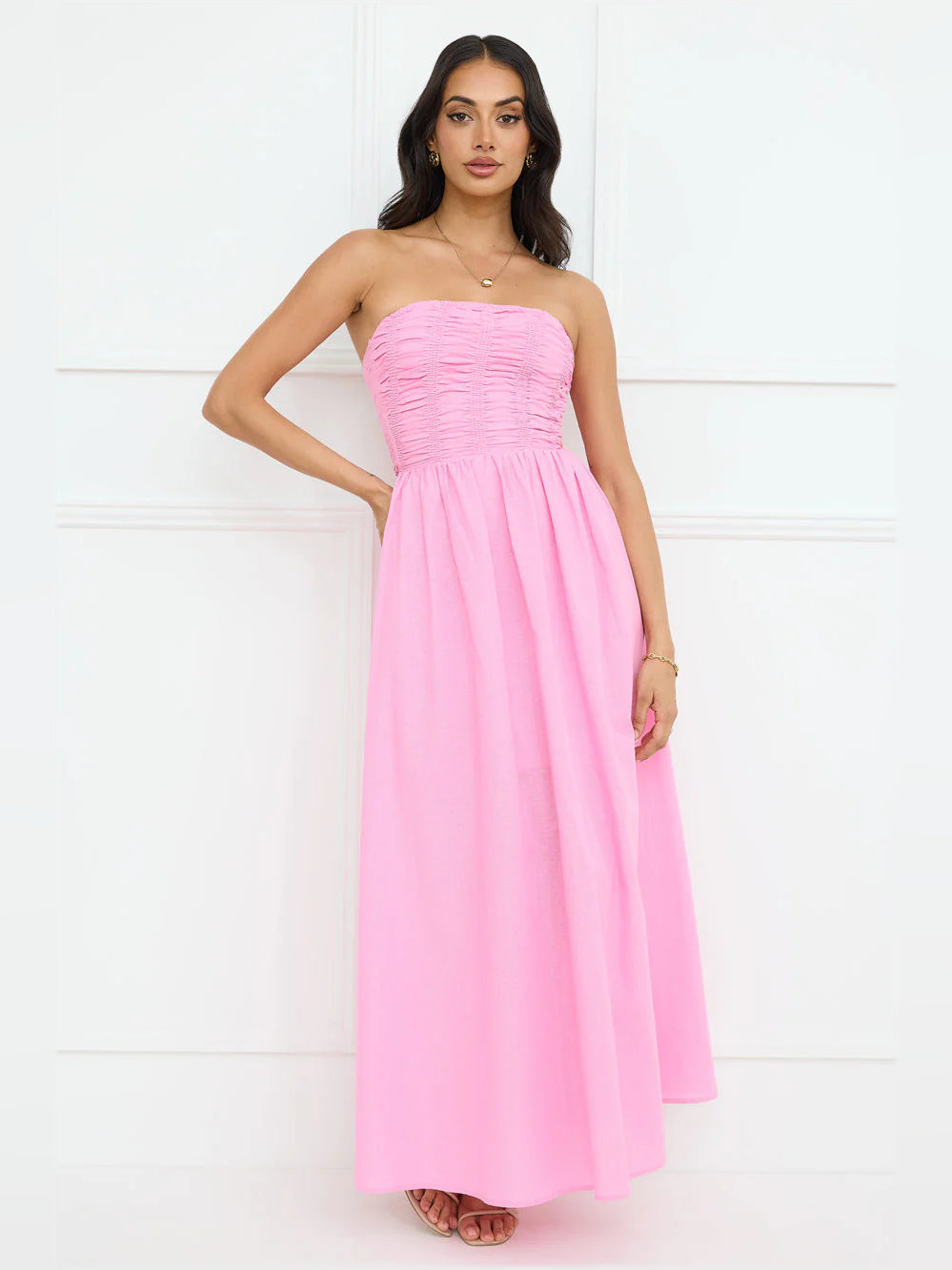 Pink strapless maxi formal dress with gathered ruched bodice and flared skirt
