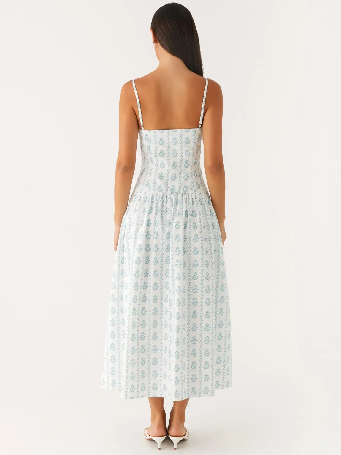 Back view of light blue printed midi dress with spaghetti straps and gathered skirt