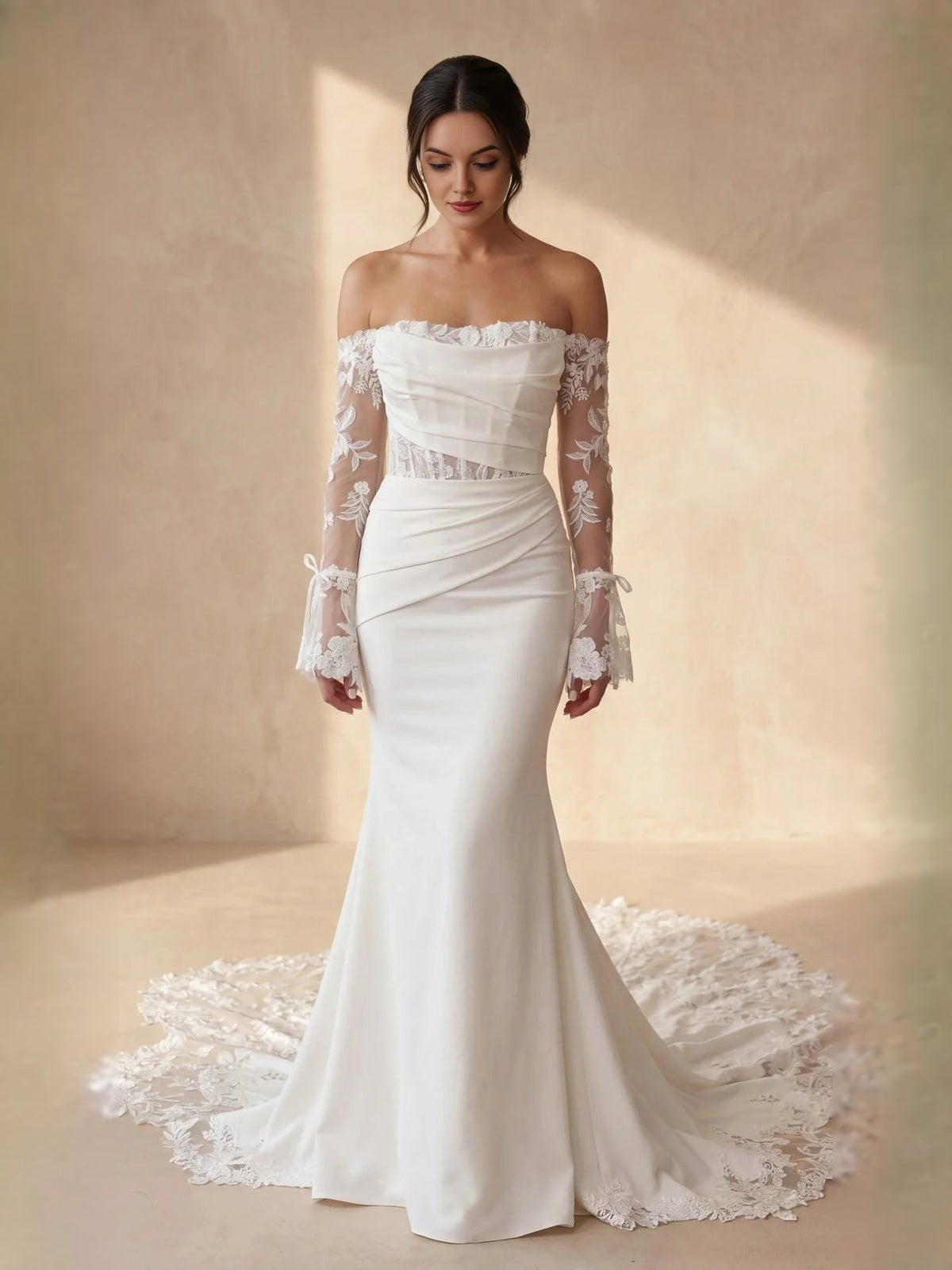 Ivory off-shoulder mermaid wedding dress with lace sleeves and flowing drape