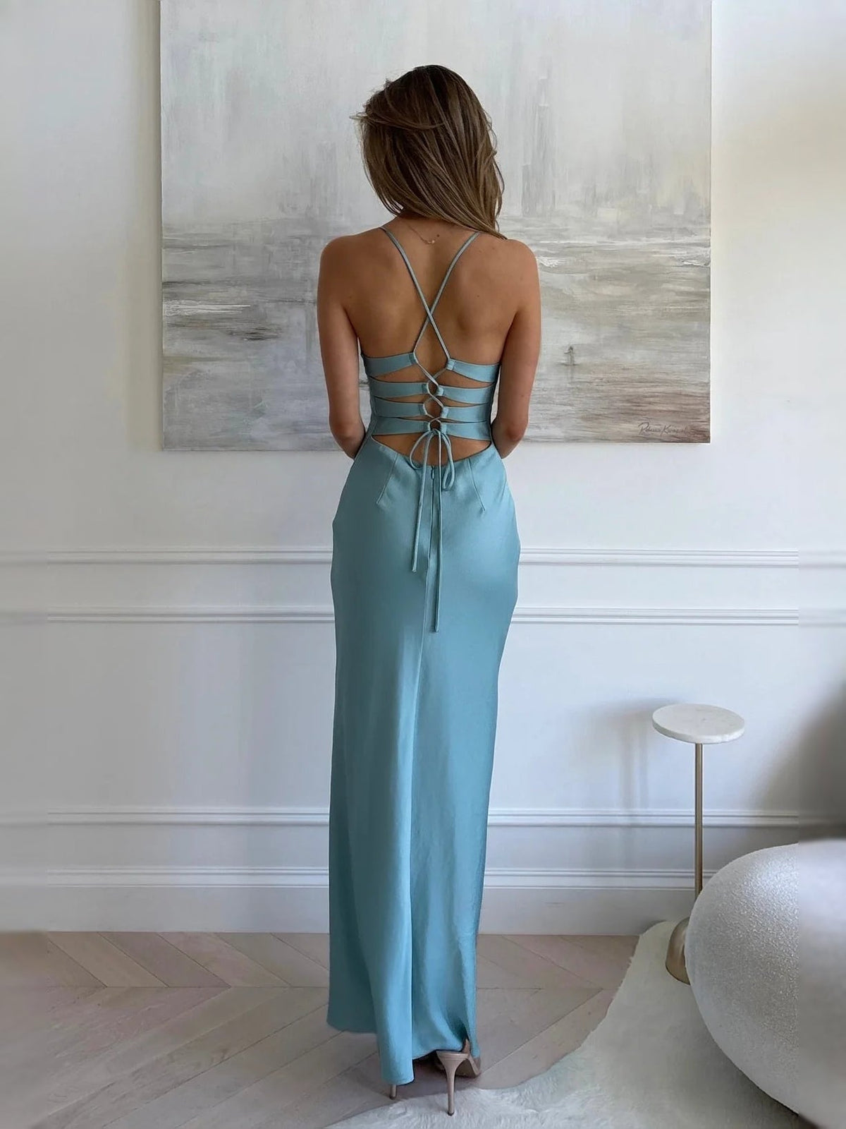 Aqua backless cut-out prom dress with crisscross straps and lace-up tie at waist.