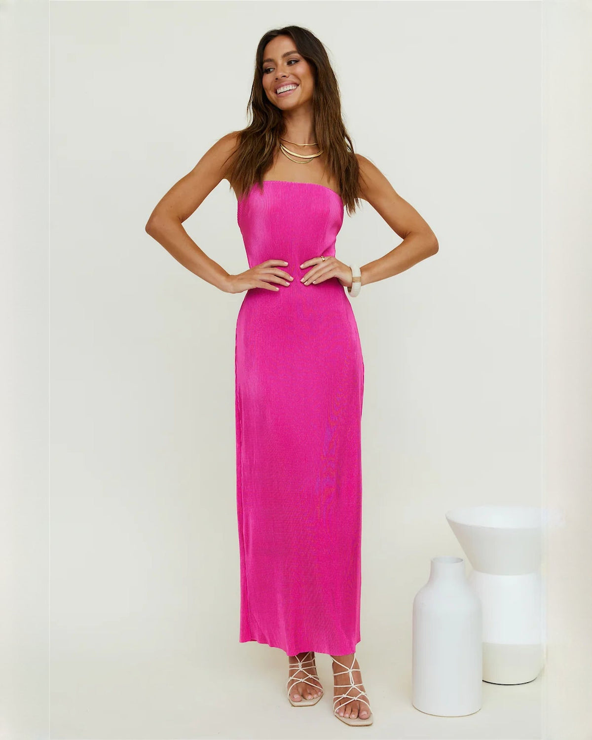 Pink strapless satin bridesmaid maxi dress with A-line skirt and hem slit detail
