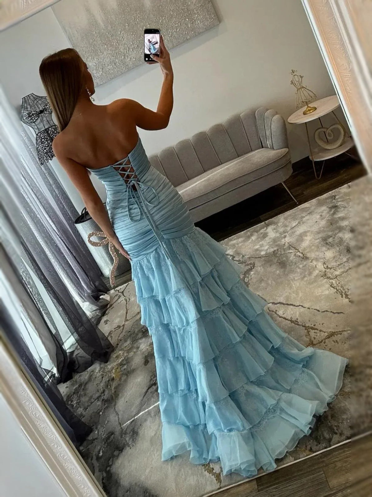 Light blue ruched corset prom dress with back lattice detail and tiered ruffles