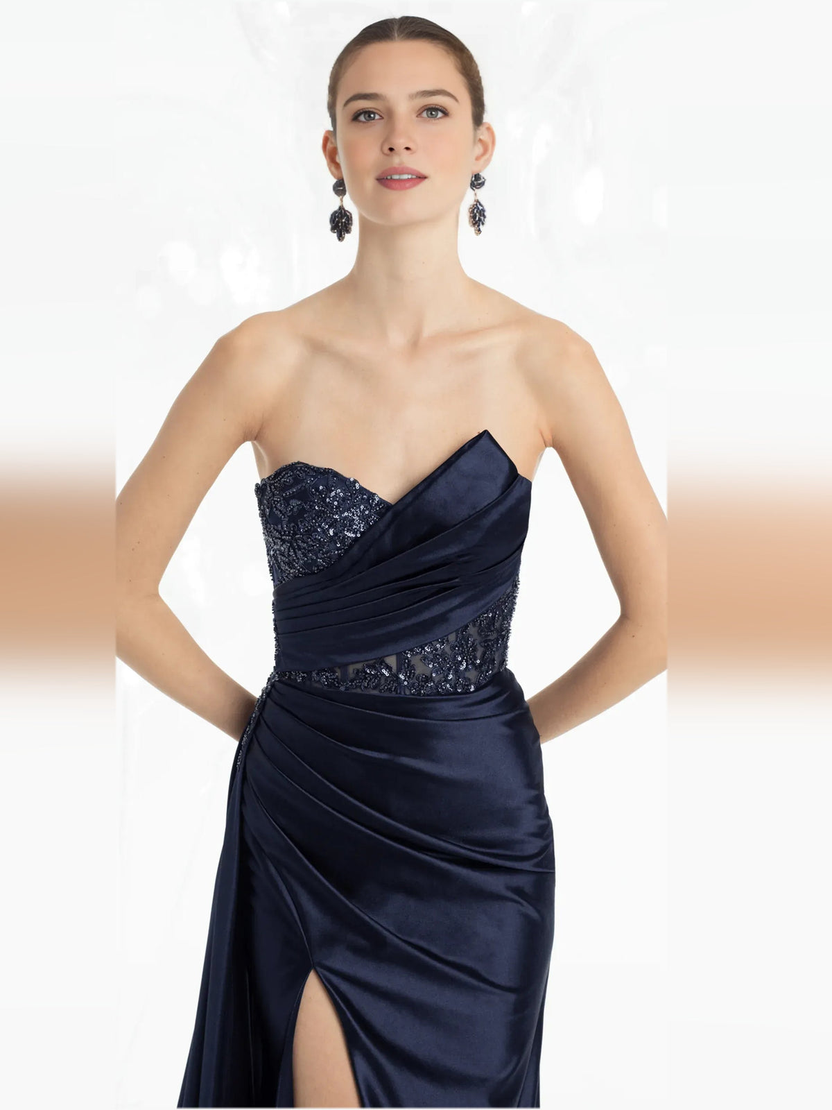 Dark navy strapless formal dress with beaded sweetheart neckline and draped wrap waist