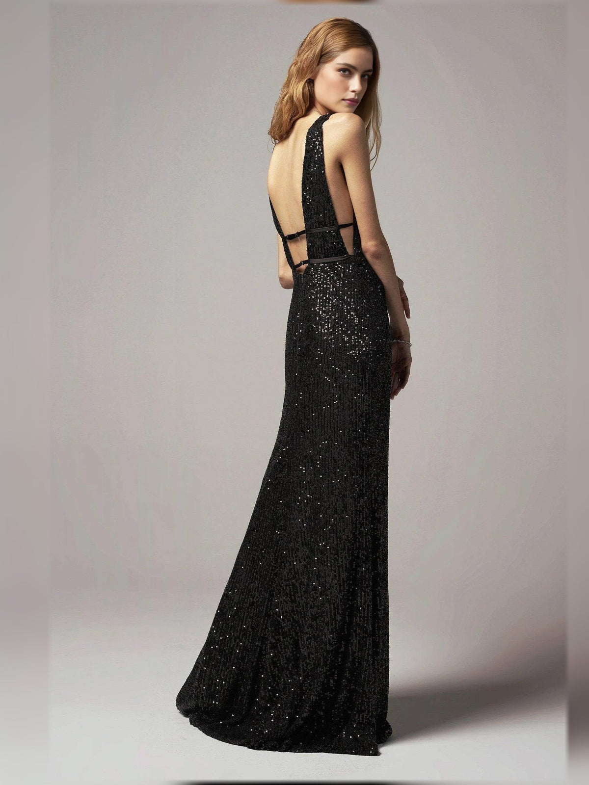 Black beaded open-back sheath floor-length formal dress shown from the side