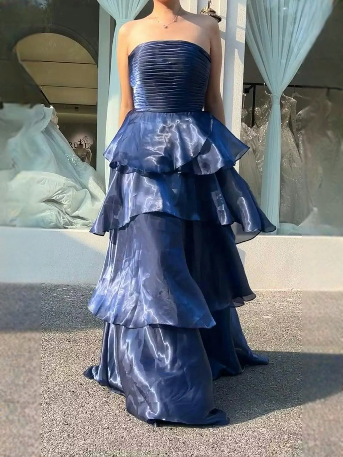 Blue strapless tiered prom dress with ruched bodice, peplum-style ruffles, floor length