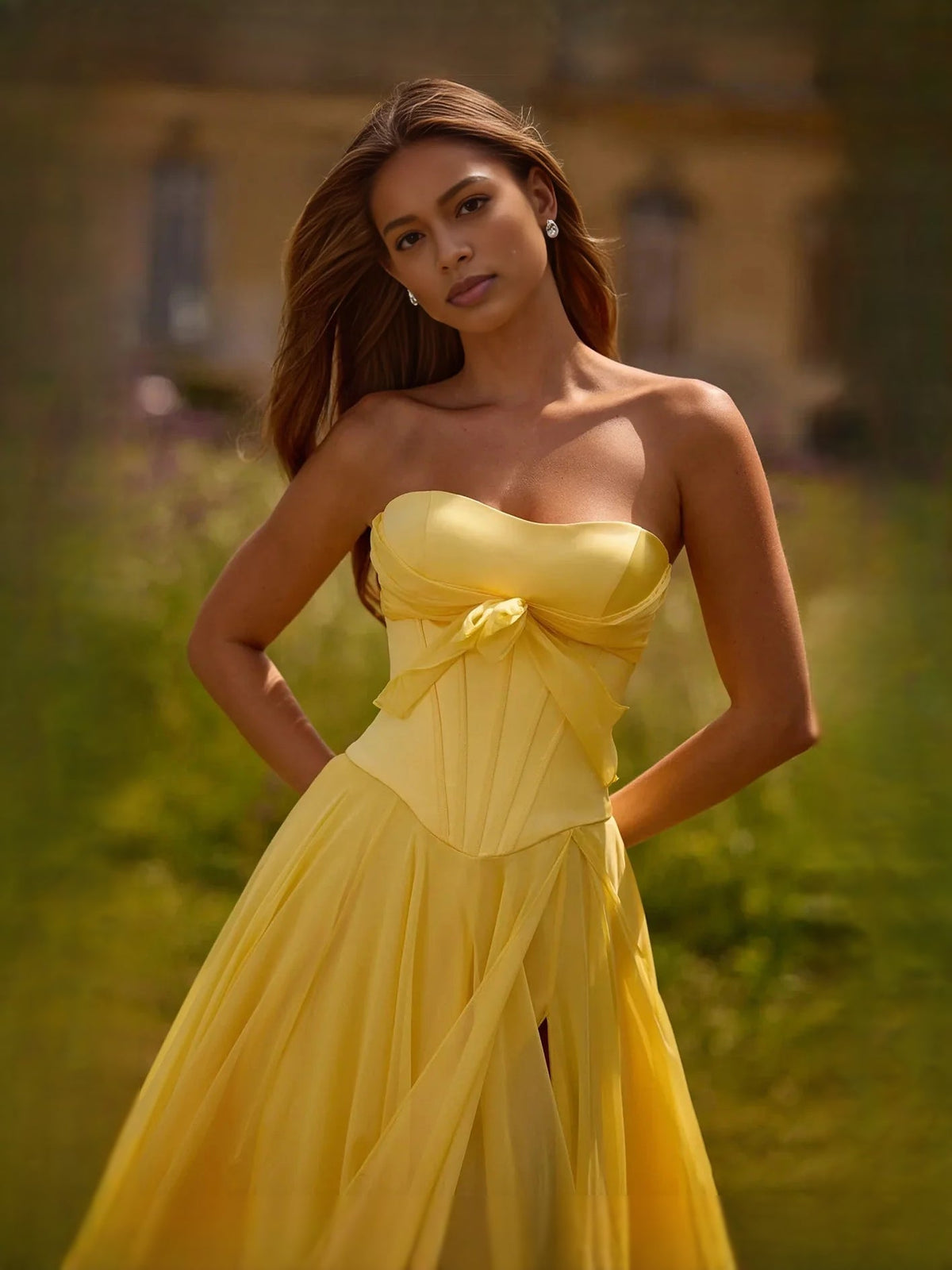 Yellow strapless sweetheart corset prom dress with bow detail and side slit
