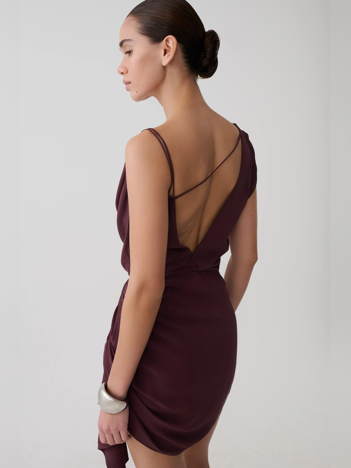 Plum satin mini dress with open back straps and draped cowl neckline