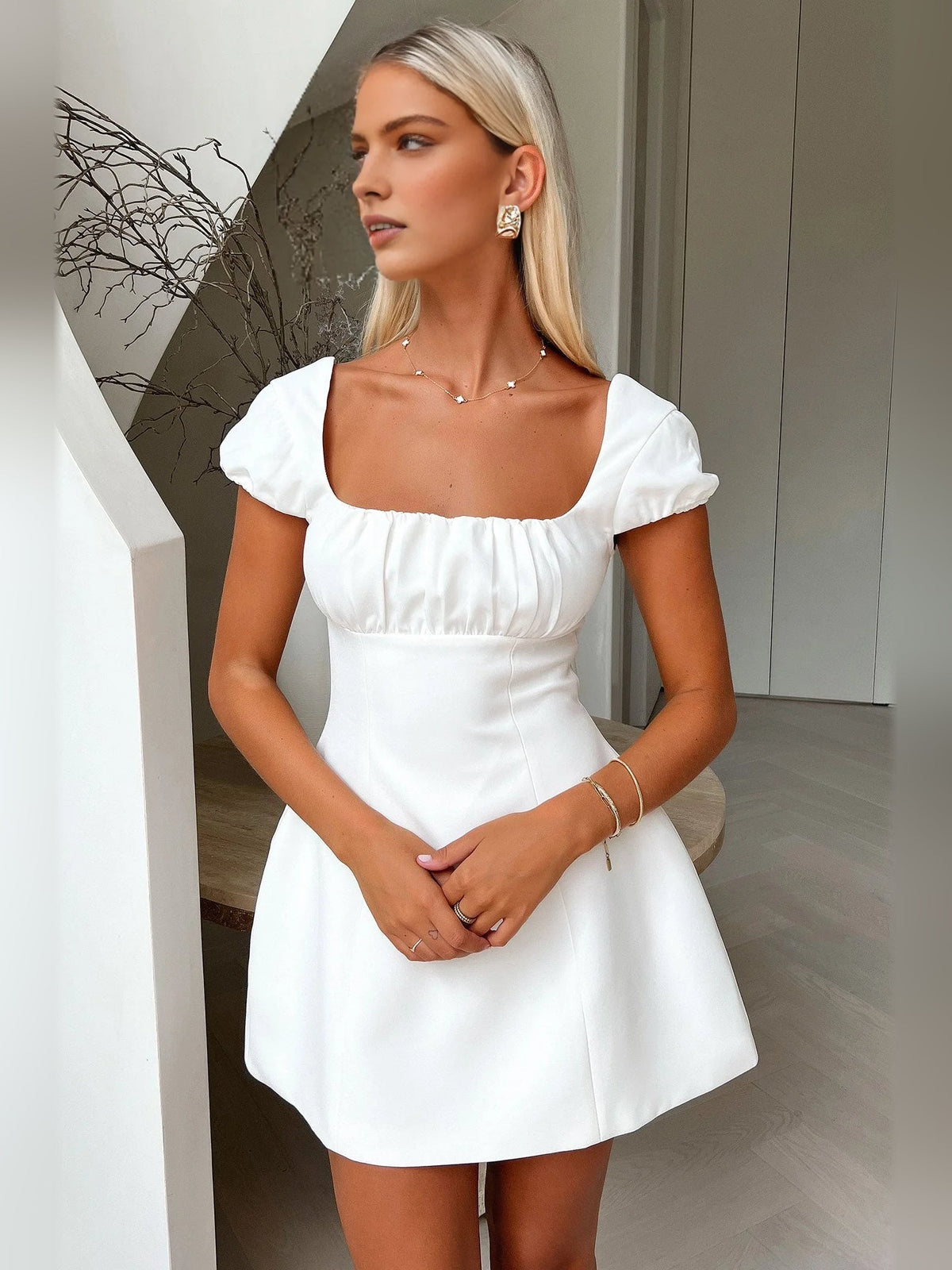 Ivory white square-neck mini dress with puff sleeves and gathered waist seams