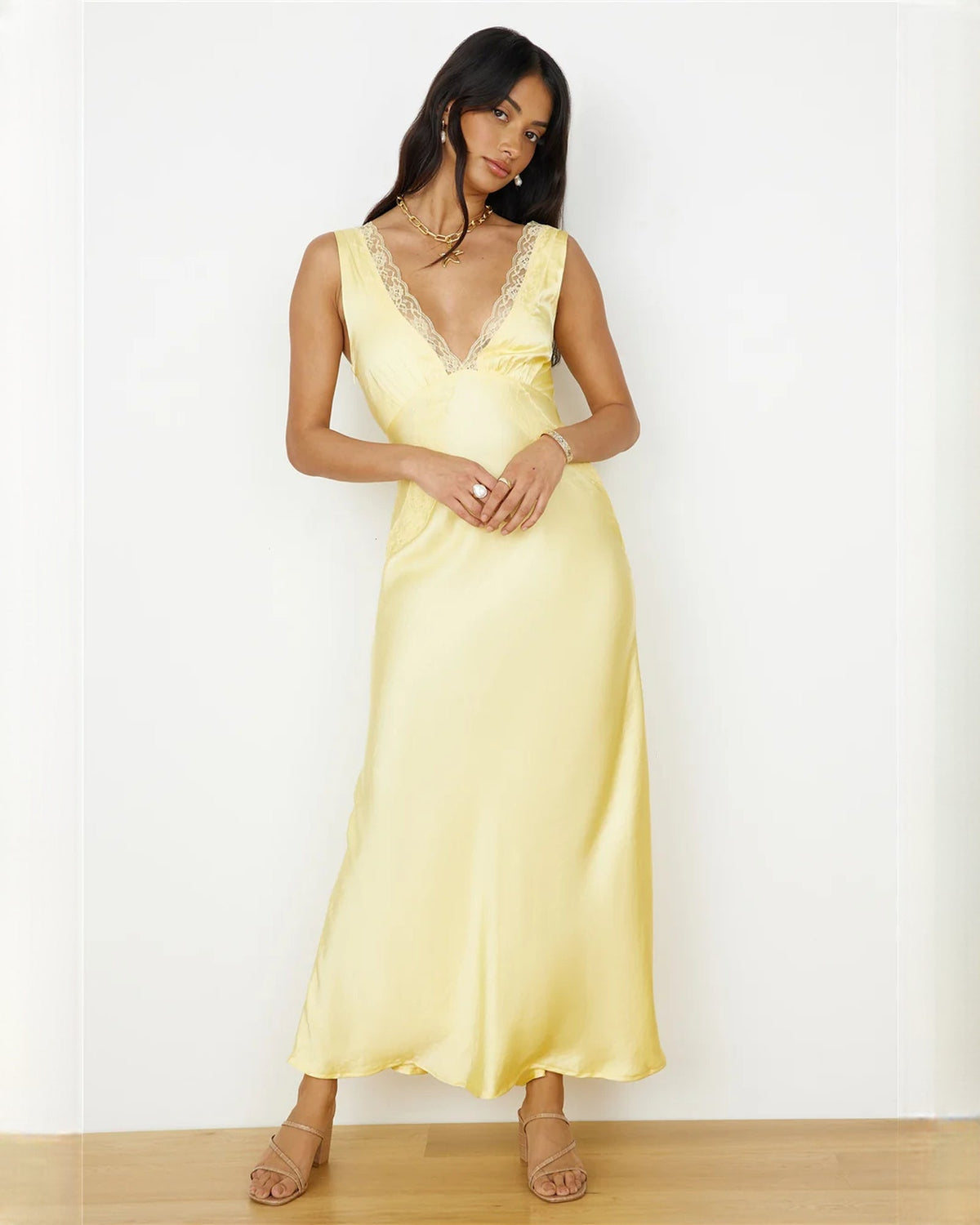 Light yellow sleeveless satin A-line maxi dress with lace-trim V-neck and draped skirt