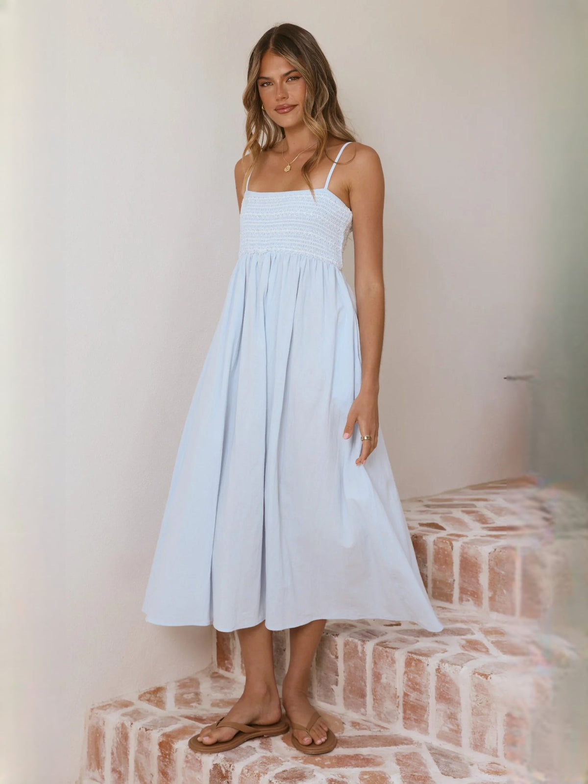 Light blue midi dress with smocked bodice and full gathered skirt