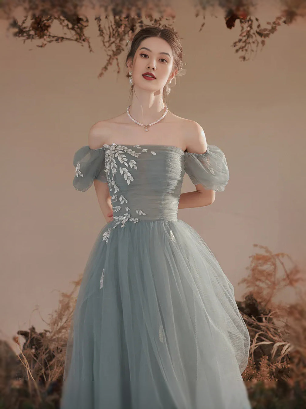Mist blue tulle maxi dress with square neckline, floral corset detail, and off-shoulder puff sleeves