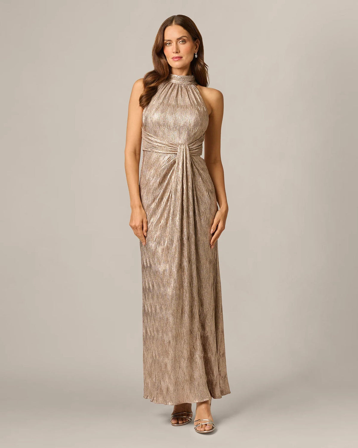 Rose-gold halter maxi gown with textured shimmer, draped waist, and front slit
