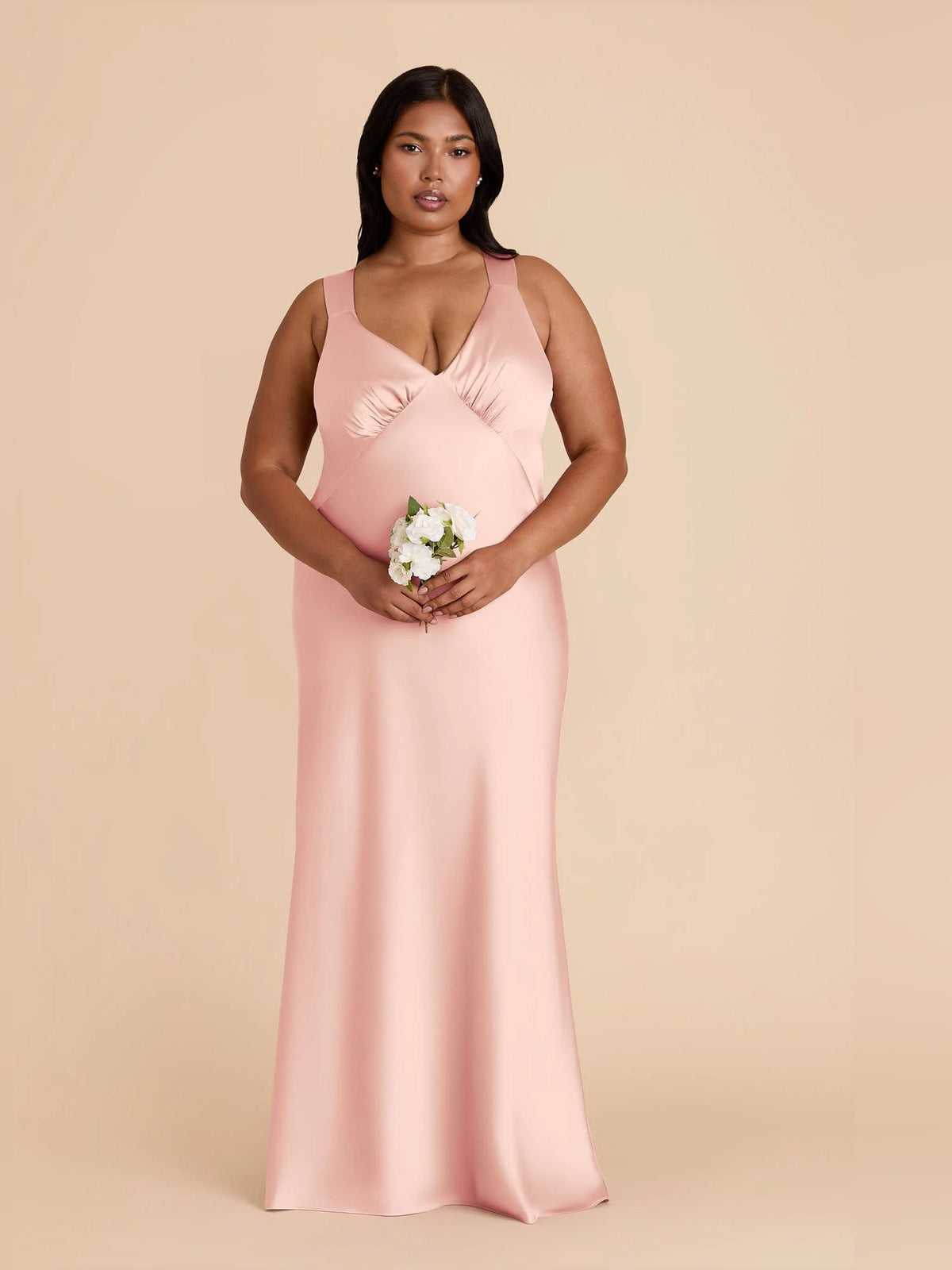 Blush pink satin ruched V-neck A-line maxi bridesmaid dress, sleeveless, front view with bouquet