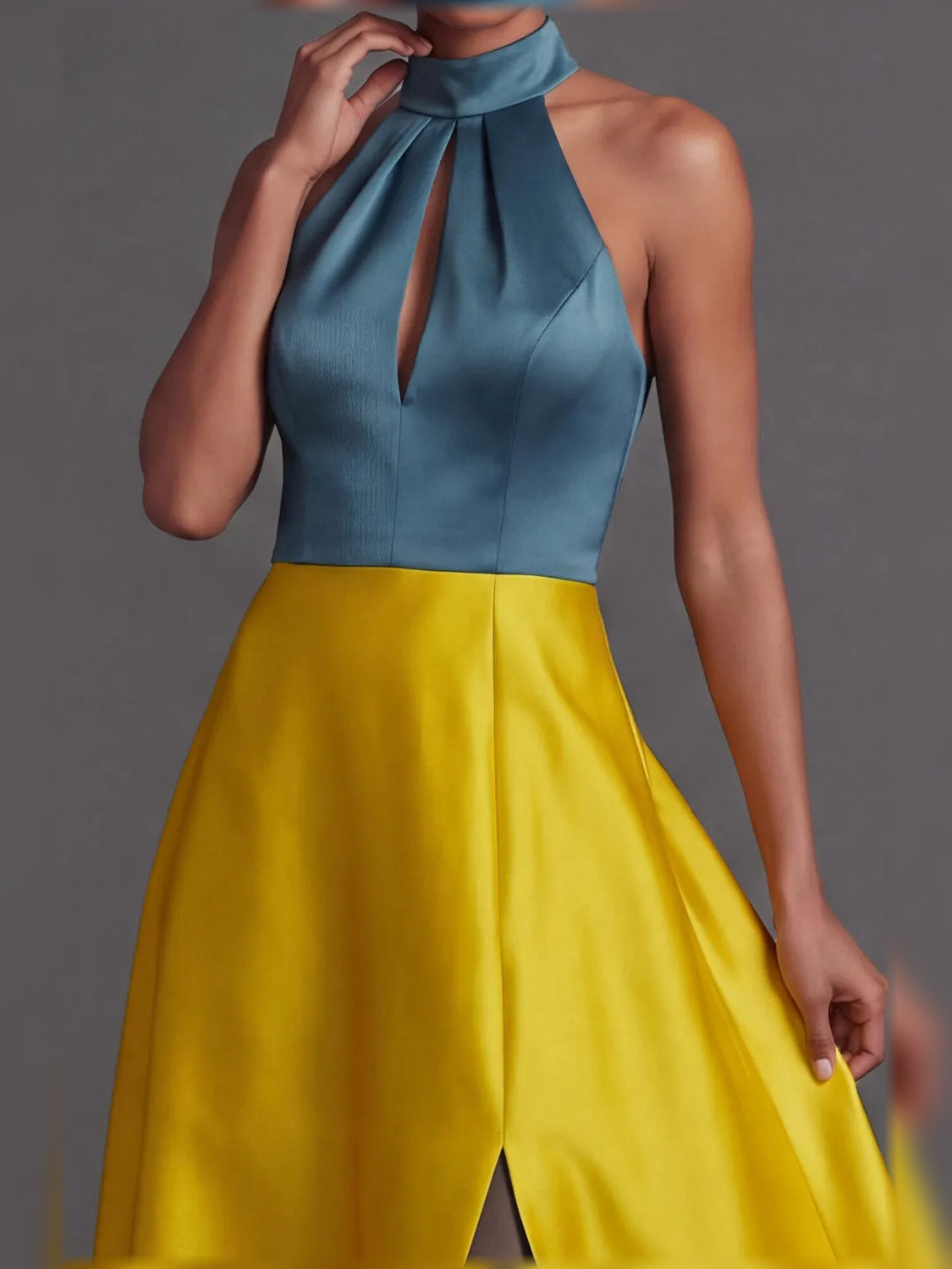 Two-tone halter neck dress with draped neck detail and floor-length skirt