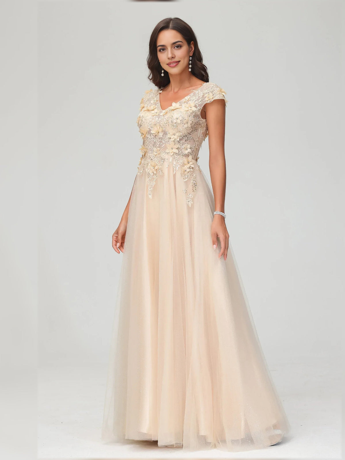 Champagne floor-length formal dress with V-neck, floral appliqué, and cap sleeves