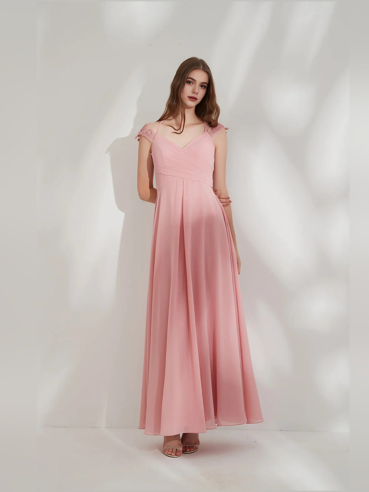 Pink chiffon V-neck bridesmaid maxi dress with ruched waist and ruffled cap sleeves