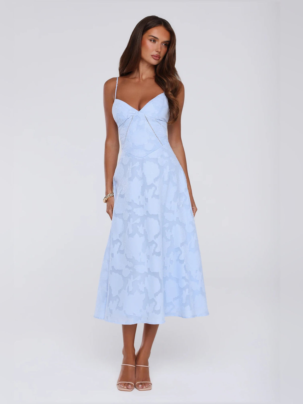 Light blue midi dress with sweetheart neckline, thin straps, and abstract print