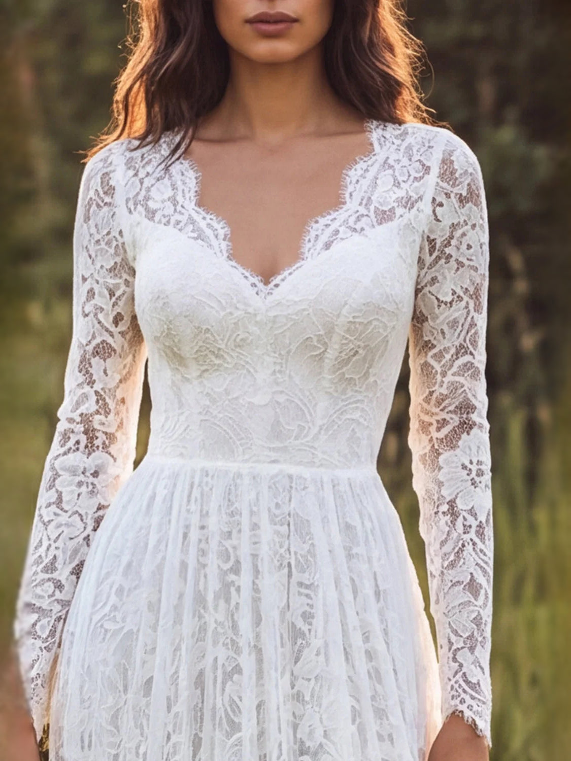 Ivory lace V-neck wedding dress with long sleeves and fitted bodice, tiered A-line skirt