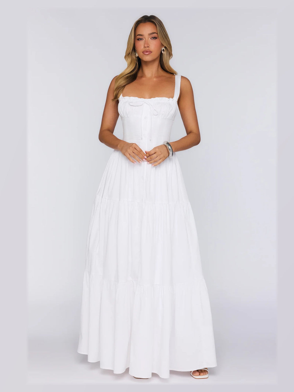 White formal dress with structured woven fabric construction and maxi hem