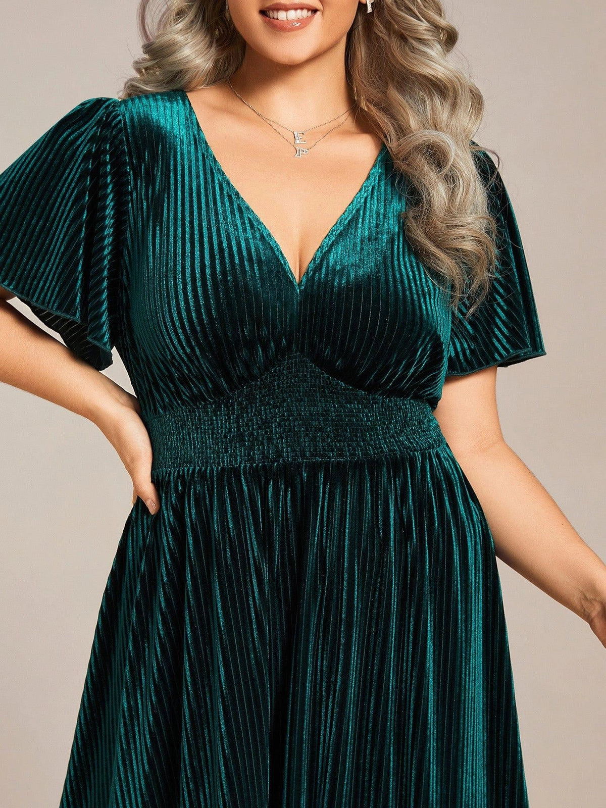 Dark green velvet A-line midi dress with V-neck and flutter sleeves