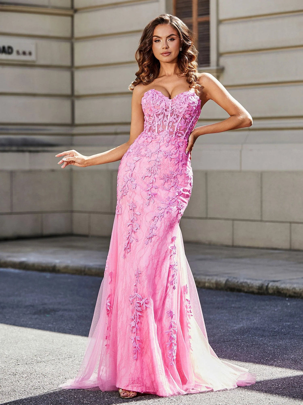Pink corset sweetheart mermaid prom dress with ruched floral appliques and sheer hem