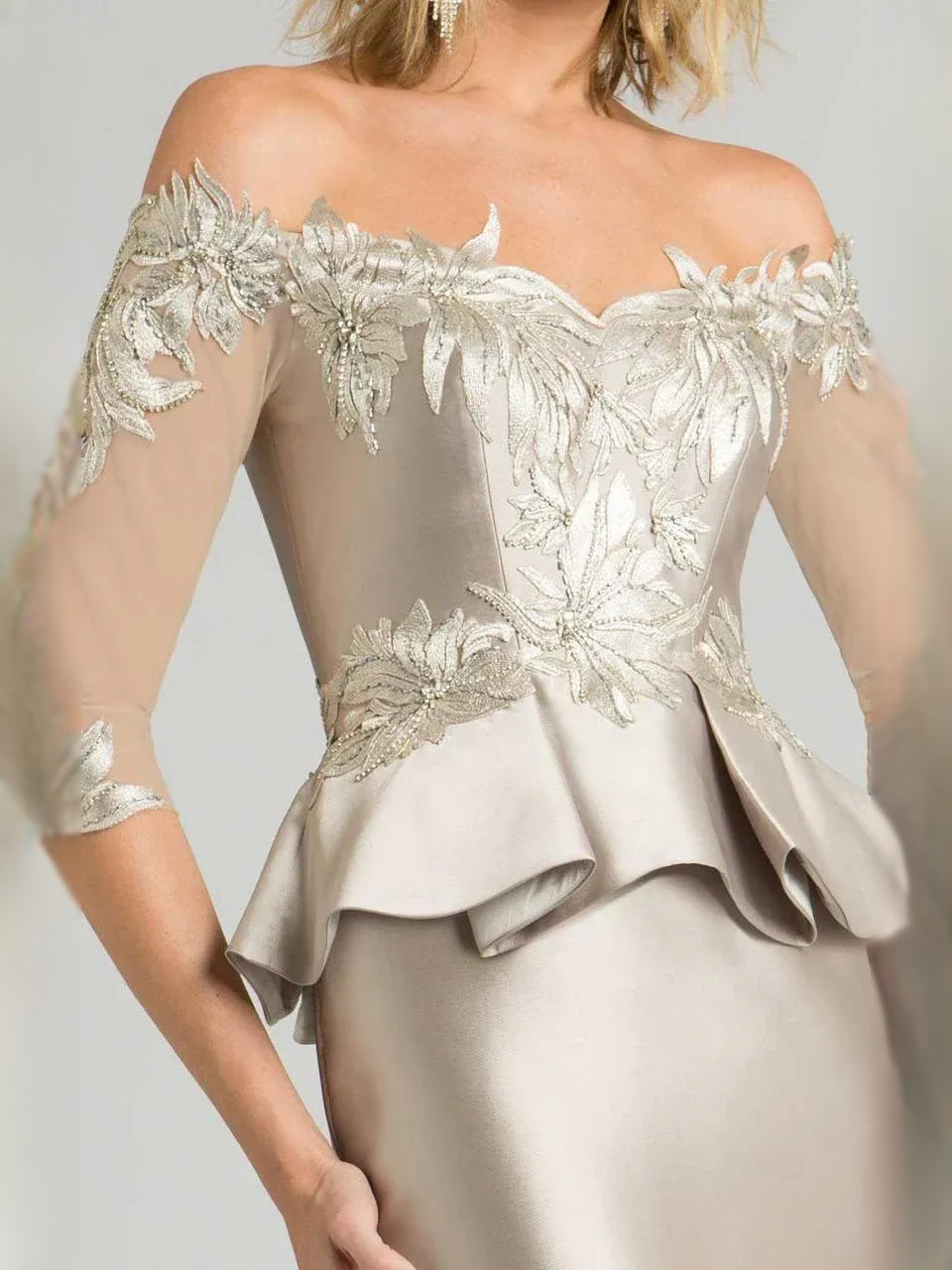 Champagne off-shoulder gown with silver beaded floral embroidery and peplum detail