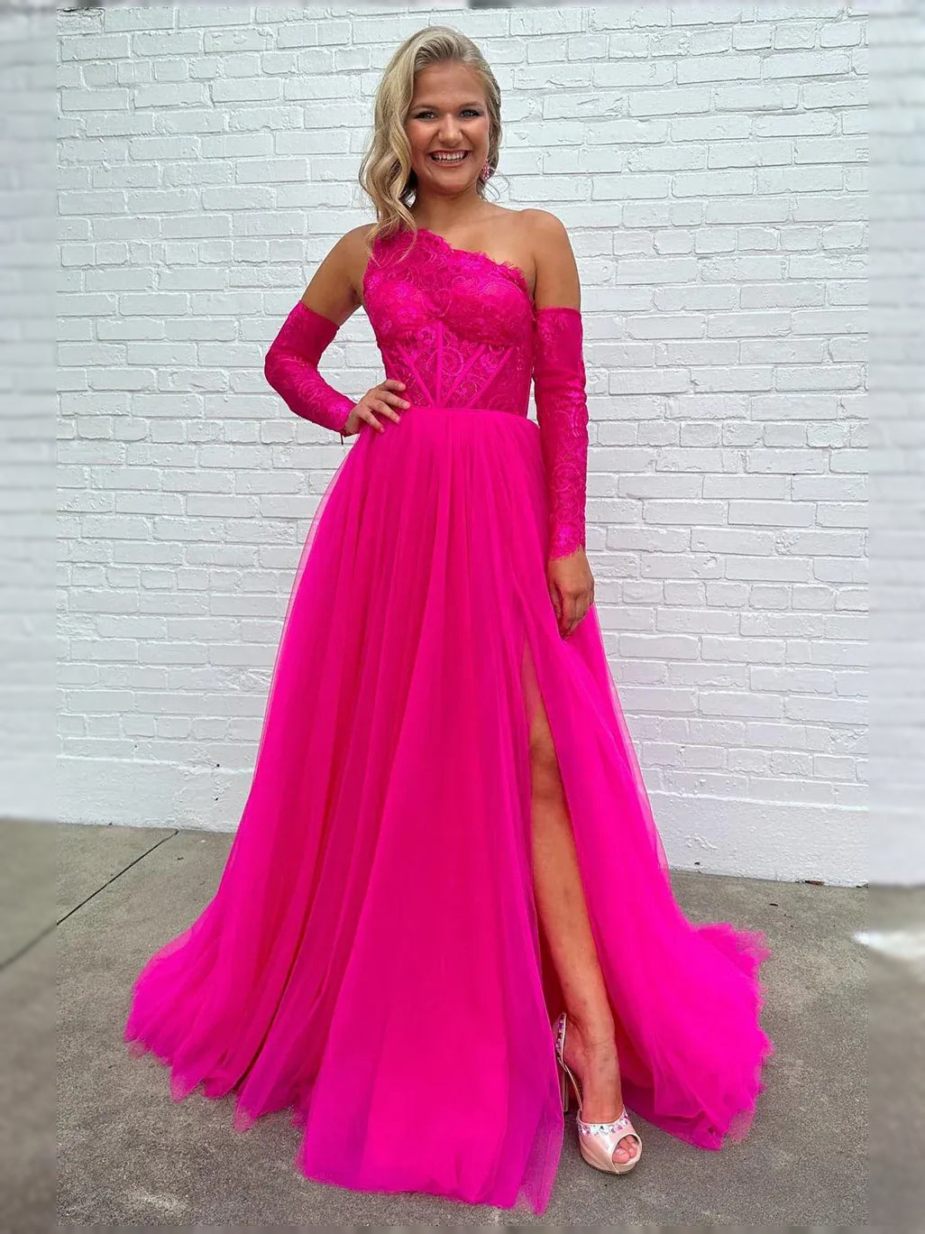 Hot pink draped sweetheart corset ball gown with lace bodice, long sleeves, and tulle skirt