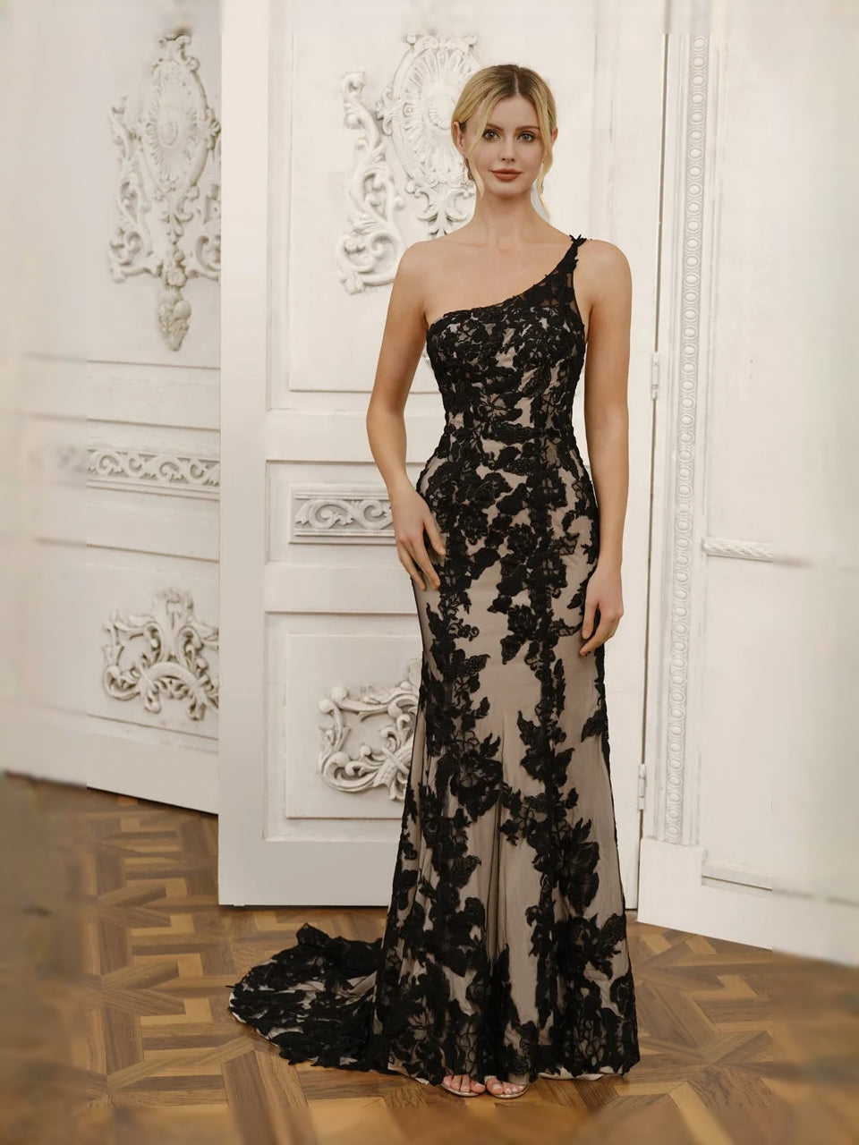 Black one-shoulder mermaid wedding dress with floral lace detail and floor-length tulle hem