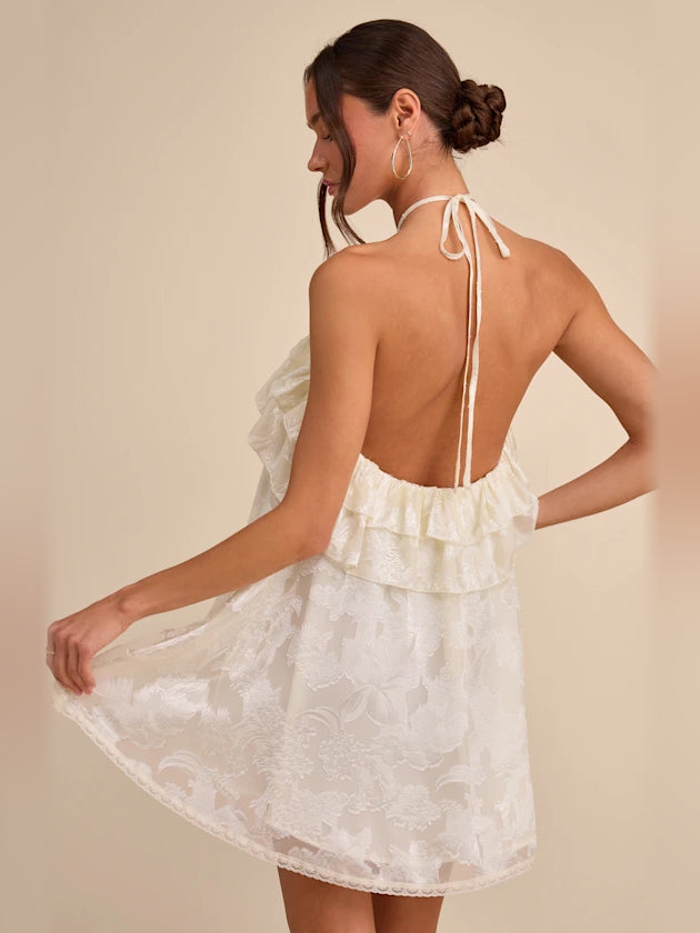Ivory floral halter mini dress with open back and tied halter straps