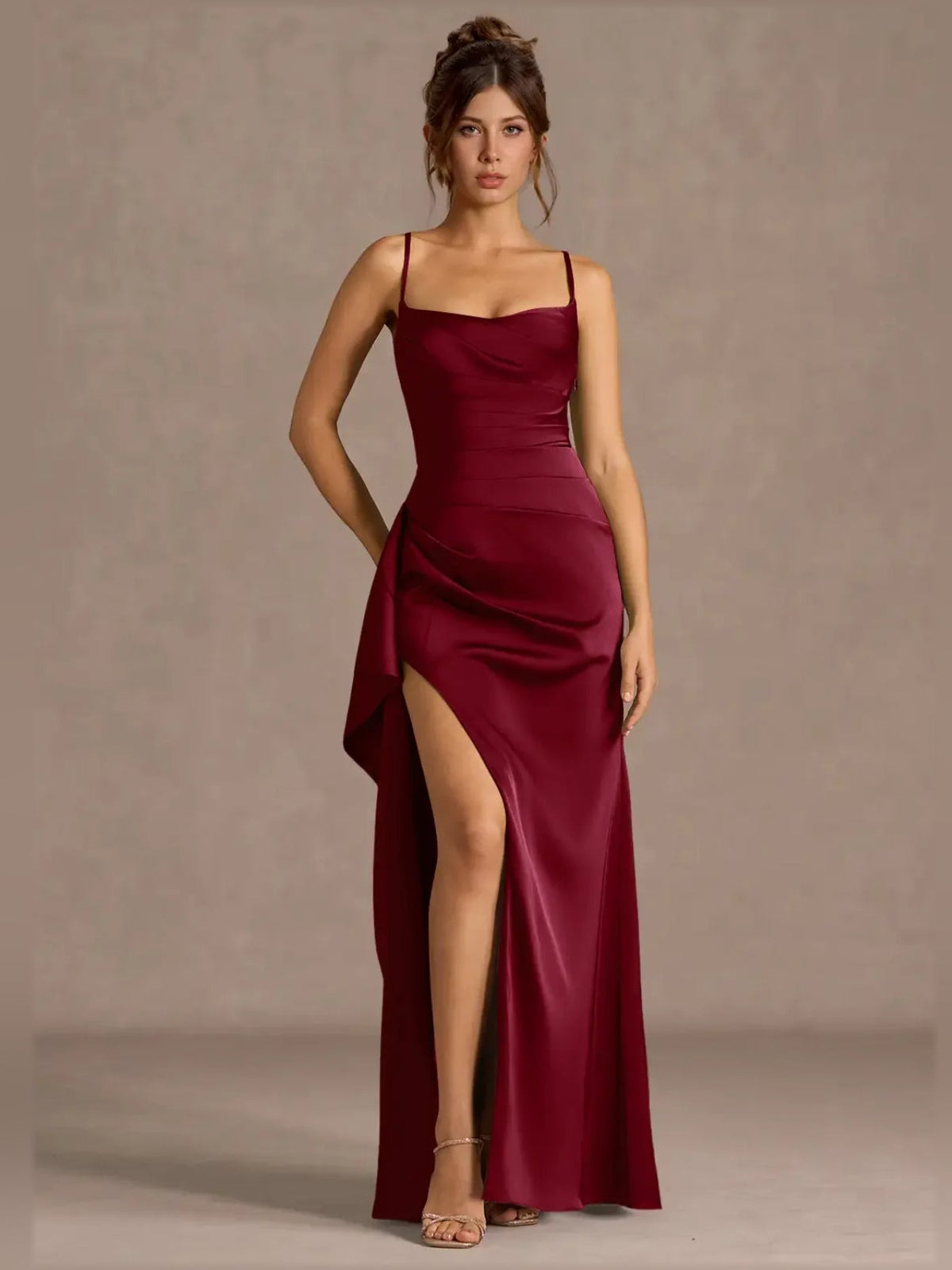 Burgundy sweetheart formal dress with spaghetti straps, ruched detail, and thigh-high slit.