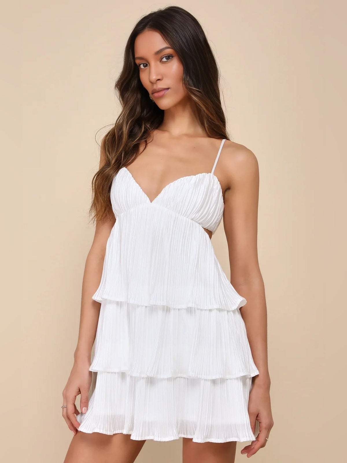 White satin mini dress with tiered ruffle layers and spaghetti straps