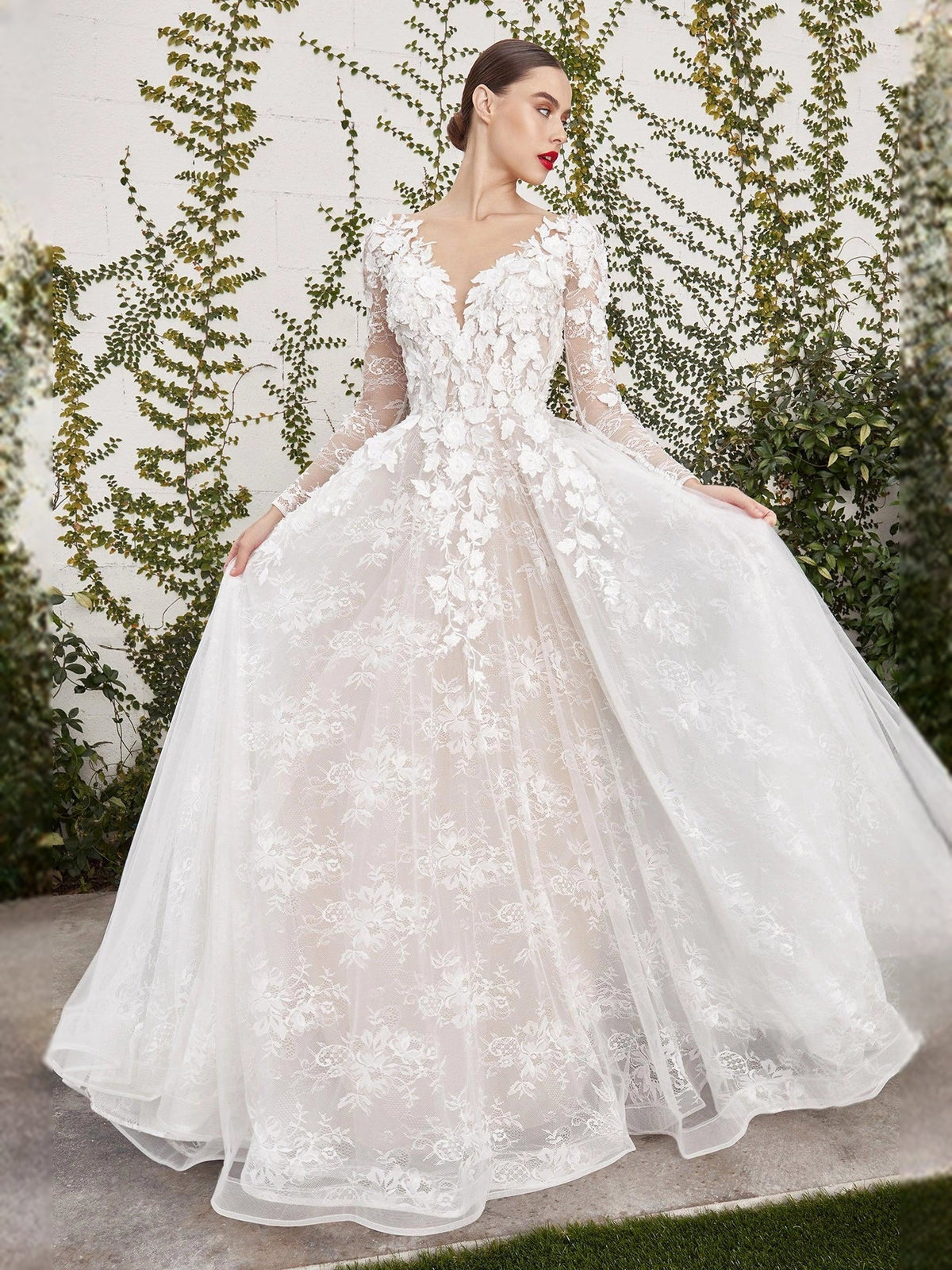 Ivory lace wedding dress with V-neck, long sleeves, corset bodice, and full tulle skirt