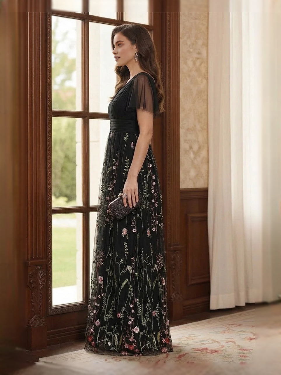 Black V-neck A-line tulle dress in side profile with ruched waist and floral embroidery